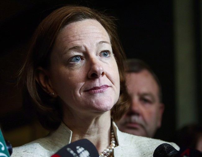 Then Alberta Premier Alison Redford speaks to reporters in Calgary, on March 15, 2014. Reports Tuesday say Redford is resigning from her Calgary seat, effective immediately.