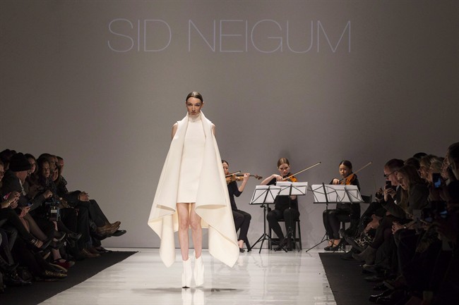 A model shows a creation from Sid Neigum while walking the runway during Toronto Fashion Week in Toronto on Monday March 17, 2014. Neigum is one of the finalists in the Mercedes-Benz Start Up program for emerging designers who will be vying to win a $30,000 bursary.