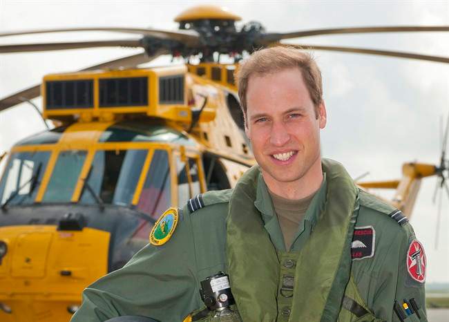 Prince William poses in front of a Sea King helicopter at RAF Valley in Anglesey Wales on June 1, 2012. 