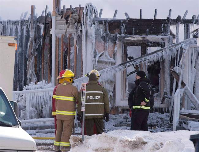 Firefighters work at the scene of a fatal fire at a seniors residence in L'Isle-Verte, Que., Thursday, January 23, 2014.