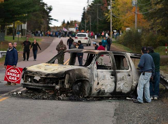 A burned police vehicle is seen in Rexton, N.B., as police began enforcing an injunction to end an ongoing demonstration against shale gas exploration in eastern New Brunswick on Thursday, Oct.17, 2013. Federal officials closely tracked the fallout of an RCMP raid on a First Nations protest against shale-gas exploration in New Brunswick, at one point raising concerns it could spawn another countrywide movement like Idle No More. THE CANADIAN PRESS/Andrew Vaughan.