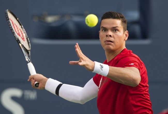 Milos Raonic, of Canada, returns a shot by Jack Sock, of the USA, in men's second round Rogers Cup tennis action in Toronto on Wednesday, August 6, 2014.