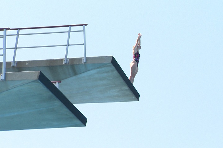 Competitive diver Suzie Lafrance plunges into the cool waters of the aquatic complex at Parc Jean-Drapeau in Montreal on August 6, 2014.