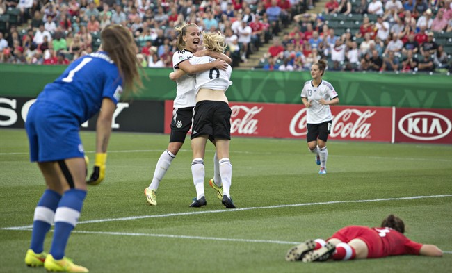 Canada goalkeeper Kailen Sheridan (1) and Jessie Fleming (8) react to a goal as Germany's Pauline Bremer (9) and Lena Petermann (18) celebrate during first half action of the FIFA U-20 Women's World Cup quarter-finals in Edmonton, Alta., on Saturday August 16, 2014.