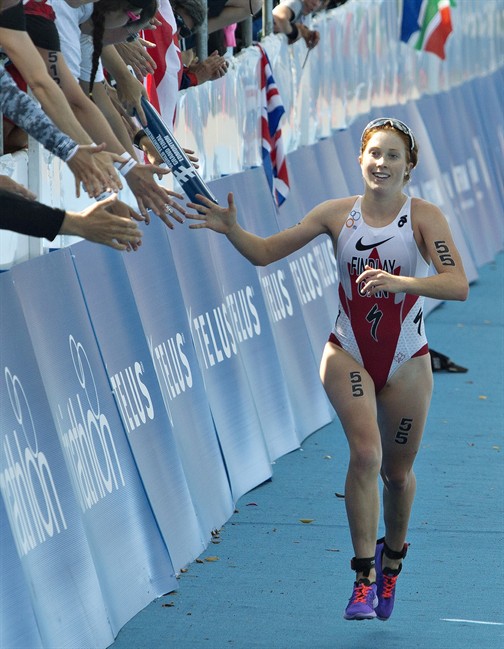 Paula Findlay of Canada is congratulated by fans as she finishes the Elite Women Championship at the ITU World Triathlon Grand Final in Edmonton, Alta., on Saturday August 30, 2014.