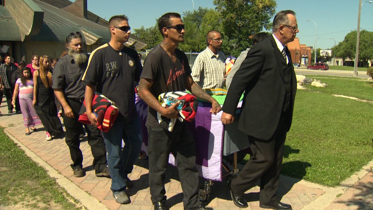 Friends and family carry casket of Faron Hall outside of Thunderbird house Wednesday morning.