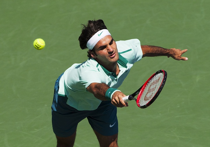 Roger Federer of Switzerland reaches to return the ball against Jo-Wilfried Tsonga of France during the Rogers Cup Men's tennis tournament final in Toronto on Sunday, August 10, 2014. 