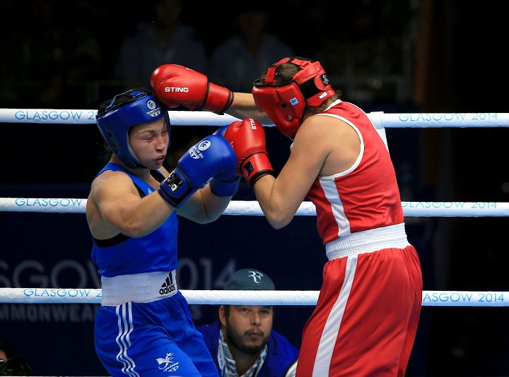 Canada's Ariane Fortin (red) in action against Wales' Lauren Price in the Women's Middle 69 - 75kg Semi-final 1 at the SECC, during the 2014 Commonwealth Games in Glasgow.
