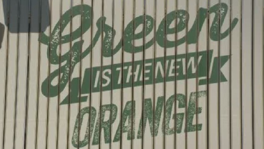 The "Green is the new Orange" billboard mounted next to BC Place. 