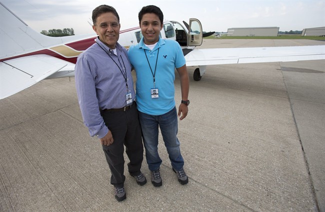  In this June 19, 2014 file photo, Babar Suleman, left, and son Haris Suleman, 17, stand next to their plane at an airport in Greenwood, Ind., before taking off for an around-the-world flight. 