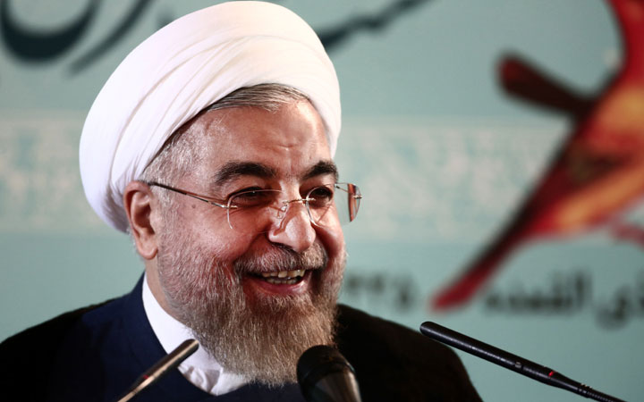 Iranian President Hassan Rouhani  smiles during a press conference in Tehran on August 30, 2014. Iran accused the United States of duplicity for imposing new sanctions on organisations linked to Tehran's nuclear programme, despite long-running but active negotiations to end the standoff.
