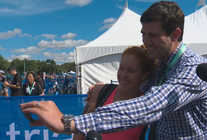 Mayor Don Iveson stops to take a selfie with triathlete Paula Findlay at the 2014 ITU World Triathlon Grand Final in Edmonton Saturday, August 30, 2014.