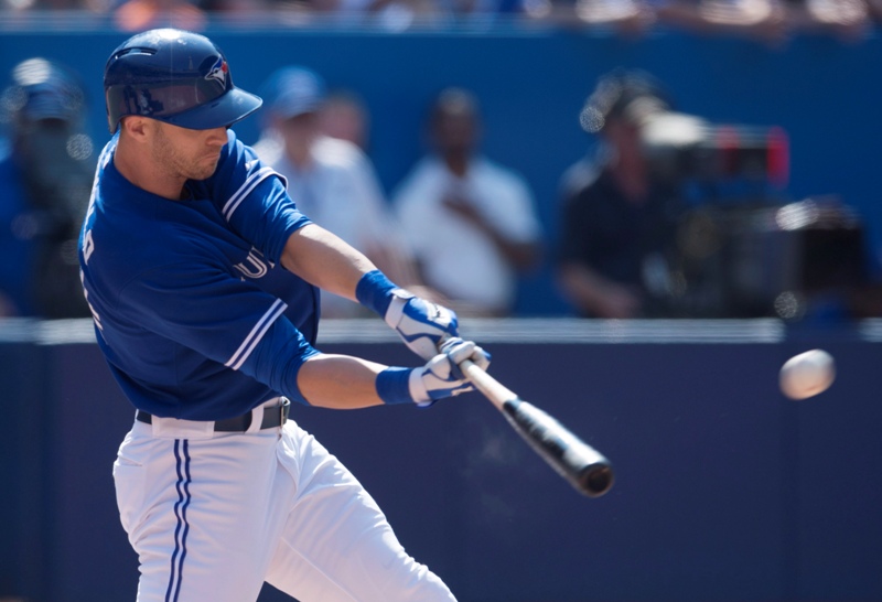 Toronto Blue Jays' Nolan Reimold hits the game-winning RBI double in the tenth inning of MLB baseball action against the Detroit Tigers in Toronto on Saturday, August 9, 2014. The Blue Jays defeated the Tigers 3-2. THE CANADIAN PRESS/Darren Calabrese.