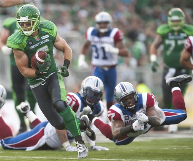 Saskatchewan Roughriders wide receiver Rob Bagg runs the ball past Montreal Alouettes corner back Billy Parker during the third quarter of CFL football action on Saturday, August 16, 2014 in Regina. THE CANADIAN PRESS/Liam Richards.