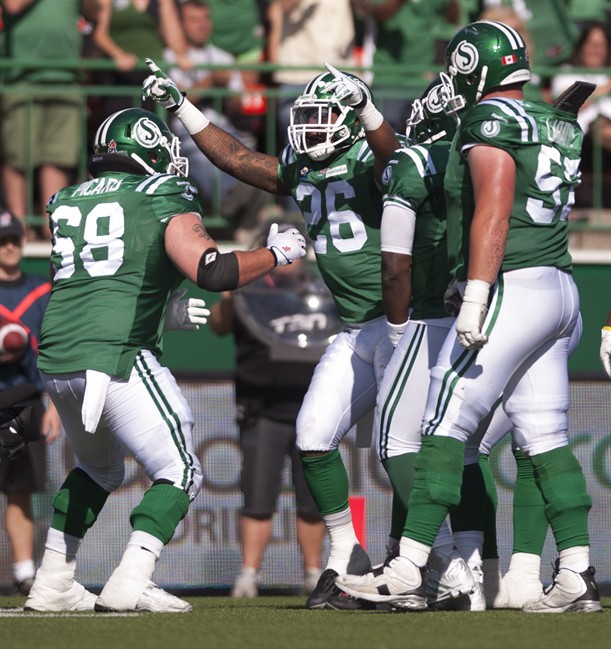 Saskatchewan Roughriders running back Anthony Allen celebrates with teammates against the Winnipeg Blue Bomber during the 4th quarter of CFL action in Regina, Sask., Sunday, August 31, 2014. The Riders defeat the Bombers 35-30. THE CANADIAN PRESS/Liam Richards.