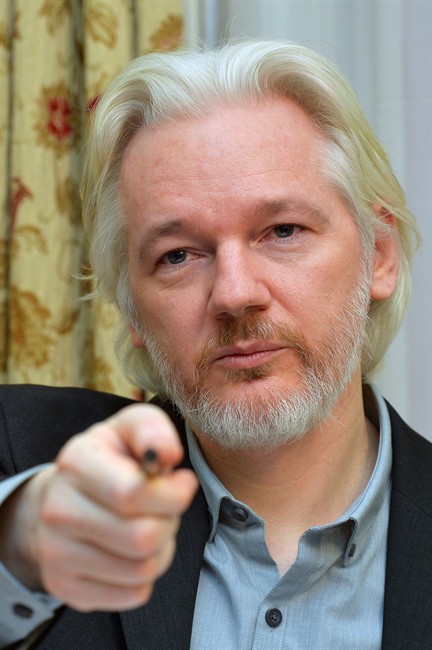 WikiLeaks founder Julian Assange speaks during a press conference inside the Ecuadorian Embassy in London, where he confirmed he "will be leaving the embassy soon", Monday Aug. 18, 2014. 