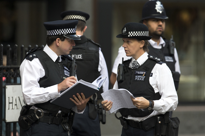 Police officers are seen in this August 18, 2014 file photo, in London, England. 