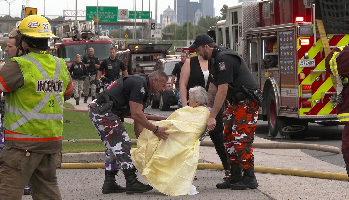 Police officers wrap up one of the residents in a blanket.