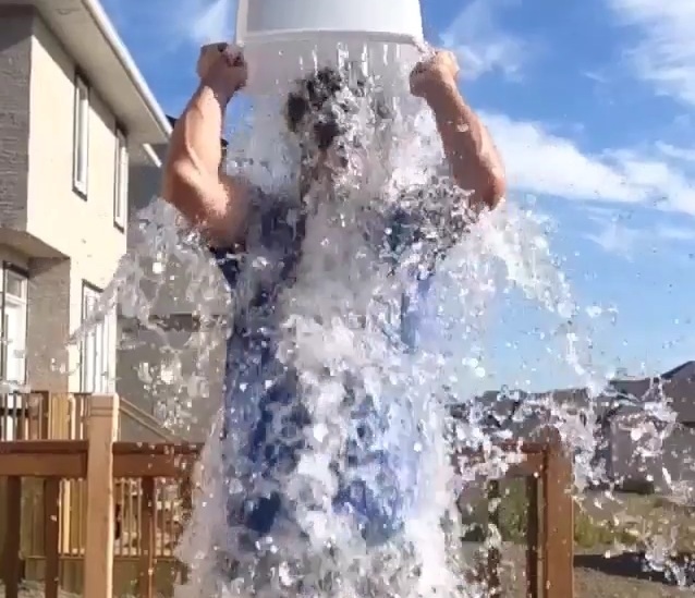 Mark Stuart dumps a a bucket of ice water over his head. 