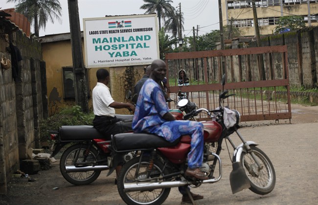 Motorcycle taxi men wait outside the gate of Mainland hospital were suspected Ebola virus victims are quarantined in Lagos, Nigeria, Thursday, Aug. 7, 2014. 