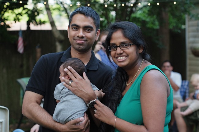 Wasim Ahmad, left, and his wife, Lakshmi Ramsoondar-Ahmad, pose with their newborn son in Merrick, N.Y. Two days after his son was born, Ahmad bought the website domain with his son’s name.