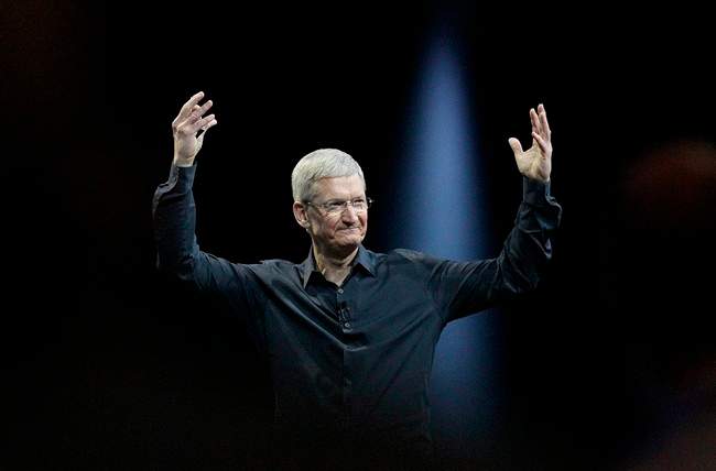 In this June 2, 2014 file photo, Apple CEO Tim Cook gestures during the Apple Worldwide Developers Conference in San Francisco. Apple's stock touched a new high Wednesday.