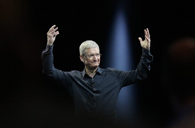 In this June 2, 2014 file photo, Apple CEO Tim Cook gestures during the Apple Worldwide Developers Conference in San Francisco. Apple's stock touched a new high Wednesday.