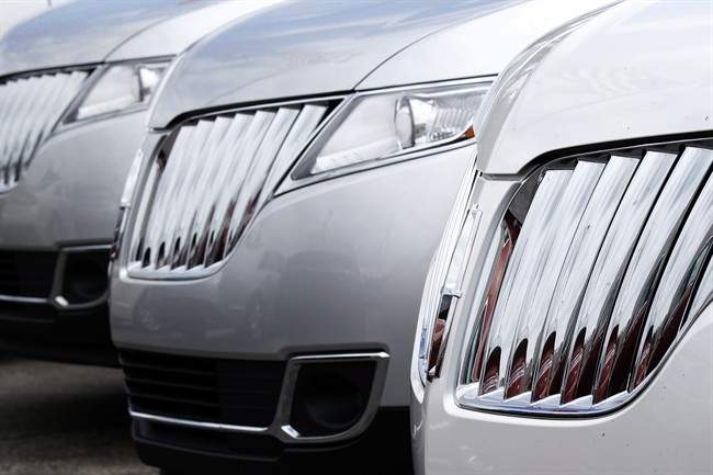 A row of 2014 Lincoln MKX SUVs are lined up on the lot of a dealership. Many Canadians are electing for bigger crossover makes as payments have been stretched over longer time frames.