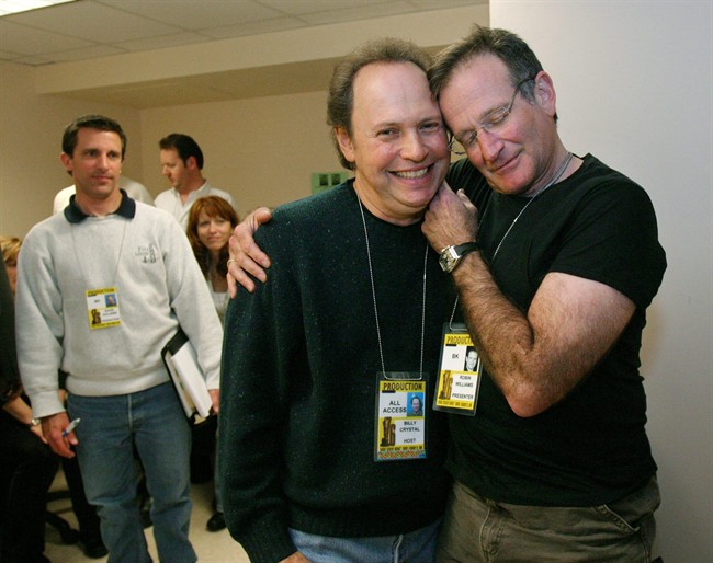  In this Feb. 28, 2004 file photo, Oscar host Billy Crystal, center, and presenter Robin Williams, right, joke around after a writers' meeting for the 76th annual Academy Awards in Los Angeles.