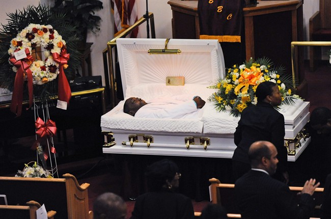 In this July 23, 2014 file photo, Eric Garner's body lies in a casket during his funeral at Bethel Baptist Church in the Brooklyn borough of New York.