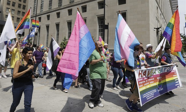 Gay marriage supporters around the Potter Stewart United States Courthouse Wednesday, Aug. 6, 2014, after holding a rally on Fountain Square in Cincinnati. Three judges of the 6th U.S. Circuit Court of Appeals in Cincinnati are set to hear arguments Wednesday in six gay marriage fights from four states, Kentucky, Michigan, Ohio and Tennessee. (AP Photo/Al Behrman).