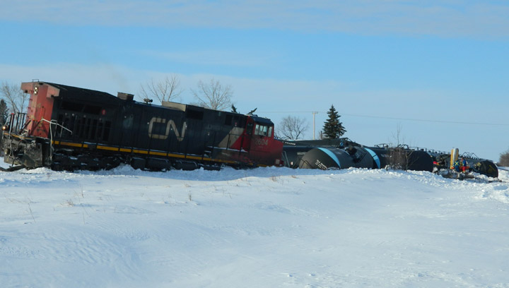 Transportation Safety Board says diminished train horn contributed to fatal 2013 crossing crash that killed grader operator, derailed 16 tank cars.