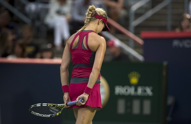 Eugenie Bouchard, from Montreal, reacts during her match against Shelby Rogers, of the United States, during first round play at the Rogers Cup tennis tournament Tuesday August 5, 2014 in Montreal. THE CANADIAN PRESS/Paul Chiasson.