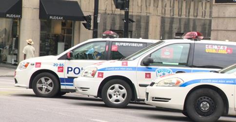 Police cruisers in Montreal are plastered with with red slogan stickers.