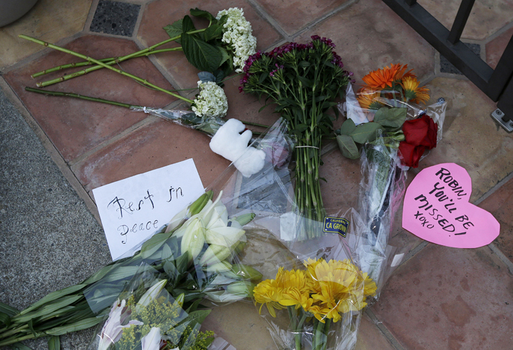 Flowers lie outside the home of Robin Williams in Tiburon, Calif., Tuesday, Aug. 12, 2014. 