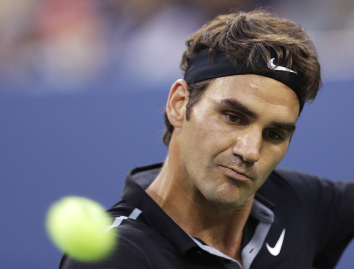Roger Federer returns the ball to Marinko Matosevic during the first round of the U.S. Open tennis tournament Tuesday, Aug. 26, 2014, in New York.