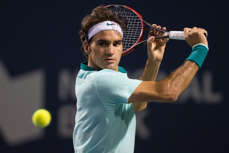 Roger Federer of Switzerland returns a shot to Feliciano Lopez of Spain during their Rogers Cup Toronto semi-final match at Rexall Centre at York University in Toronto, Ontario, August 9, 2014. Federer defeated Lopez 6-3, 6-4 to advance to the final Sunday against Jo-Wilfried Tsonga of France. AFP PHOTO / Geoff Robins.