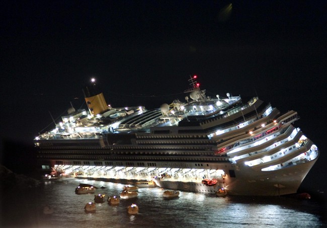 In this Jan. 13, 2012 file photo, the luxury cruise ship Costa Concordia lays on its starboard side after it ran aground off the coast of the Isola del Giglio island, Italy. 