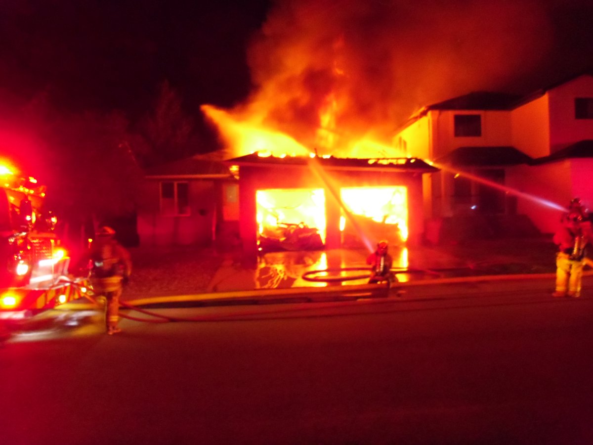 Firefighters battle a house fire on the 2800 Block of Sunninghill Crescent early Tuesday morning. The fire started in the garage, according to an official.