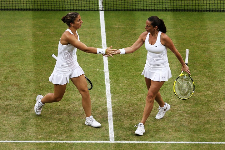 Sara Errani (L) and Roberta Vinci of Italy celebrate during their Ladies Doubles Final match against Timea Babos of Hungary and Kristina Mladenovic of France on day twelve of the Wimbledon Lawn Tennis Championships on July 5, 2014.