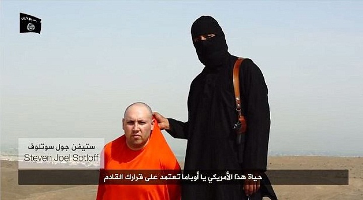 A man identified as Steven Joel Sotloff with a member of ISIS. August .