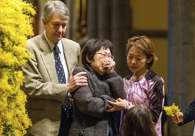 Mourners console each other during a national memorial service for the victims of Malaysia Airlines Flight 17 at St Patrick’s Cathedral in Melbourne, Autralia Thursday, Aug. 7, 2014. 