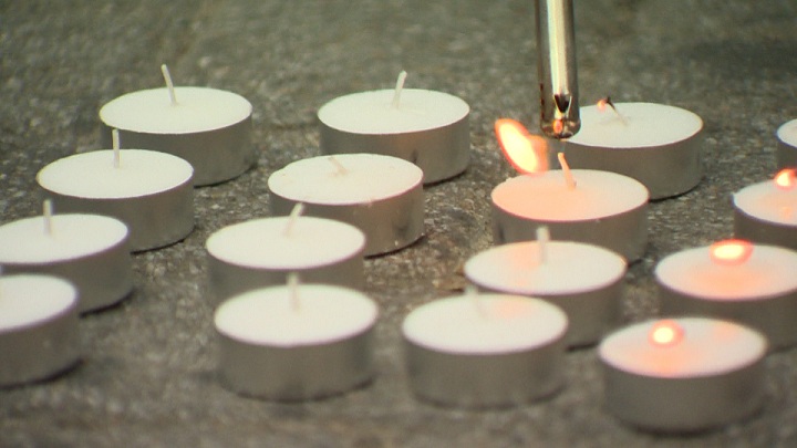 Candles spelling out the word 'freedom' are lit in Phillips Square in Montreal, Thursday August 22, 2014.