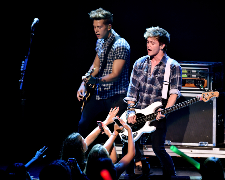 Musicians James McVey (L) and Connor Ball of The Vamps perform at the Nokia Theatre on July 30, 2014 in Los Angeles, California.  
