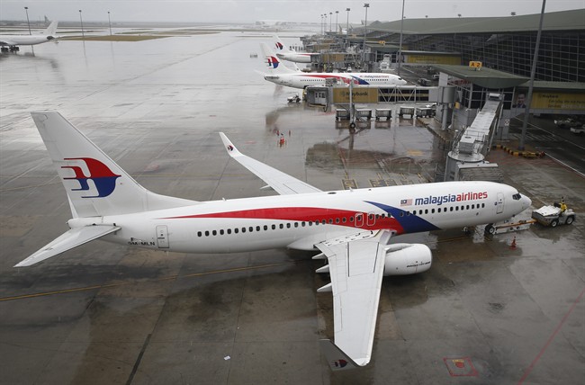 In this Aug. 8, 2014 file photo, a Malaysia Airlines Boeing 737-800 plane sits on tarmac at Kuala Lumpur International Airport in Sepang, Malaysia. 