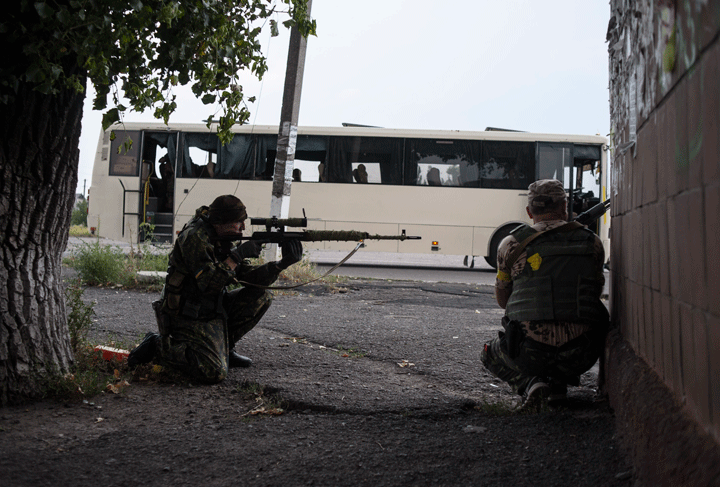 Ukrainian government soldiers from battalion "Donbass" guard their positions in the village of Mariinka near Donetsk, eastern Ukraine, Monday, Aug. 11, 2014.