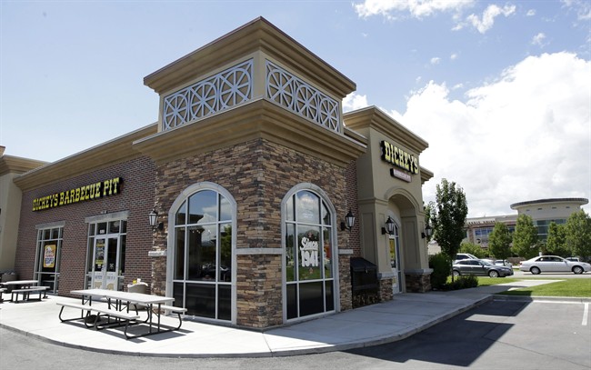 Dickey's Barbecue Pit is shown Thursday, Aug. 14, 2014, in South Jordan, Utah. Police say a woman was in extremely critical condition after drinking sweet tea laced with an industrial cleaning chemical at Dickey's Barbecue Pit. South Jordan Police Cpl. Sam Winkler says the 67-year-old woman was eating at Dickey's Barbecue Pit on Sunday when she poured herself a glass of tea from the beverage bar.  (AP Photo/Rick Bowmer).
