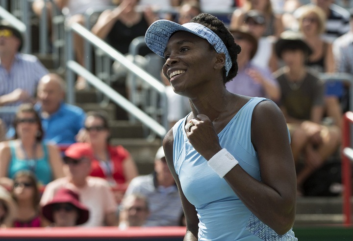 Venus Williams of the United States celebrates after beating her sister Serena 6-7, 6-2, 6-3 during semifinal play at the Rogers Cup tennis tournament Saturday, Aug. 9, 2014 in Montreal.