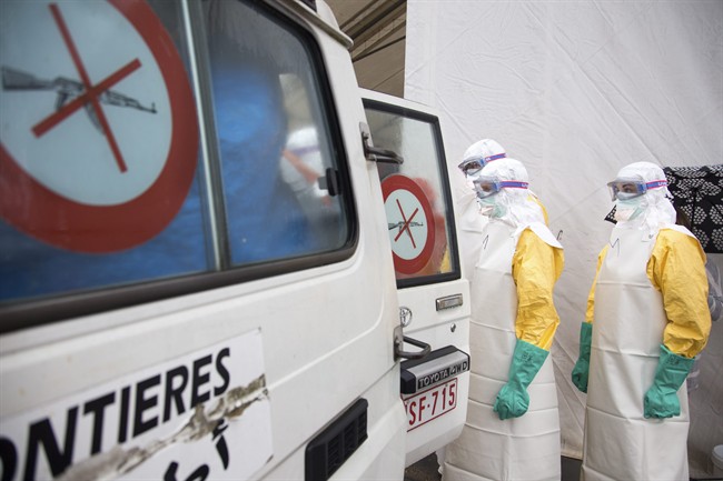 During a taining session participants simulate loading a patient into an ambulance during a training course to instruct non-governmental organisation (NGO) workers and doctors on how to deal with the Ebola virus in Brussels.