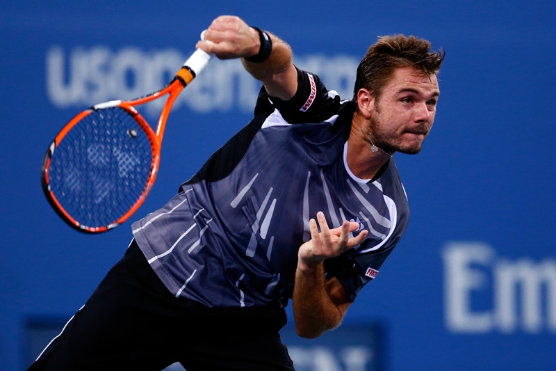 Stan Wawrinka of Switzerland returns a shot against Thomaz Bellucci of Brazil during their men's singles second round match on Day Three of the 2014 US Open. (Photo by Julian Finney/Getty Images).